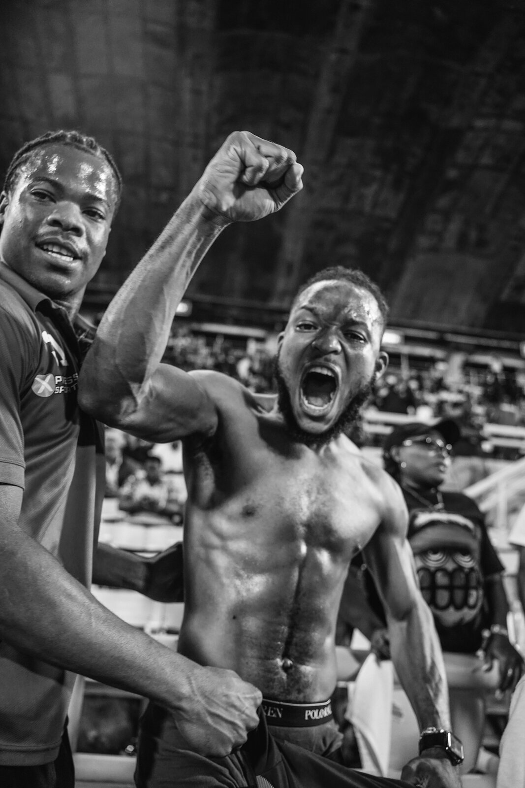Two players roar in celebration in black and white