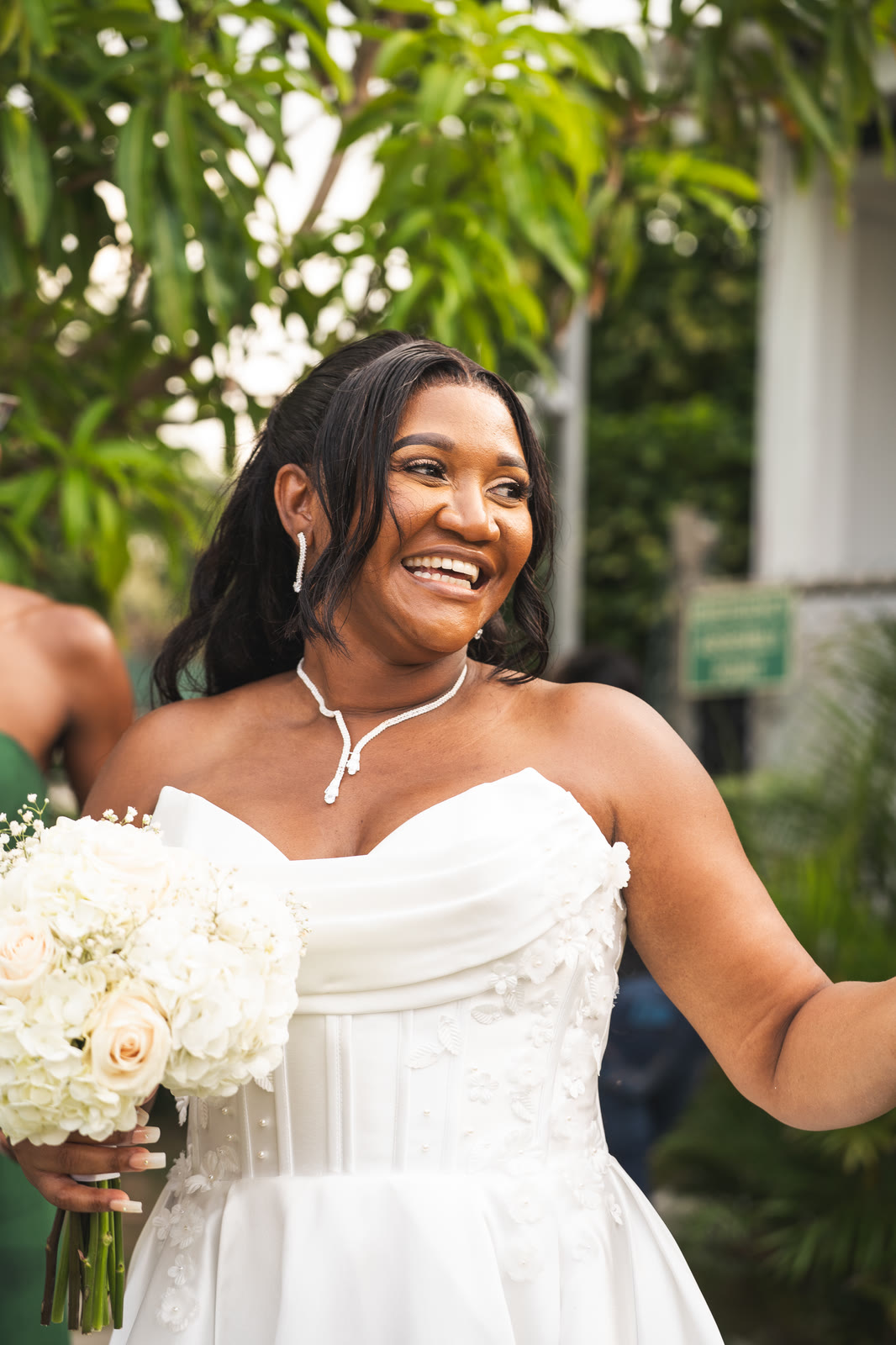 The bride laughs with her bouquet in hand