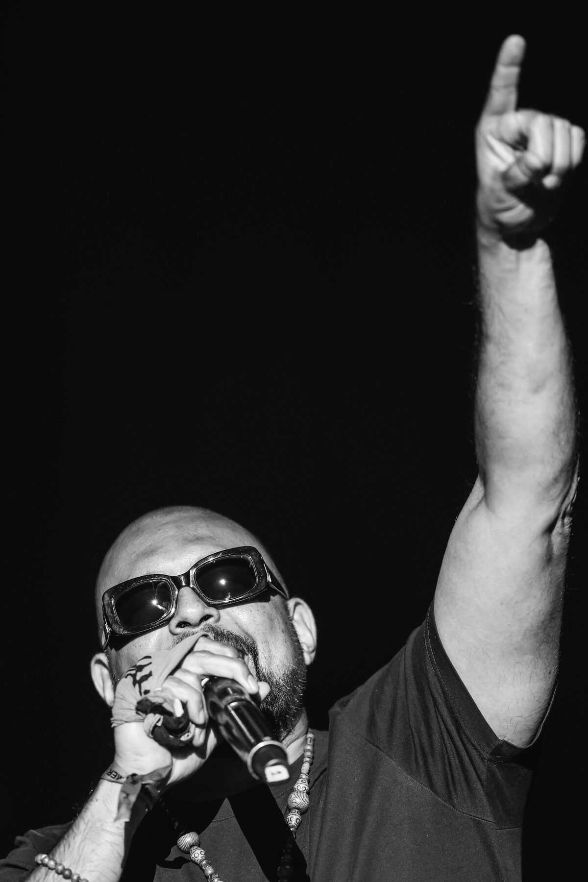 A black-and-white frame of an artist gripping the mic mid-verse