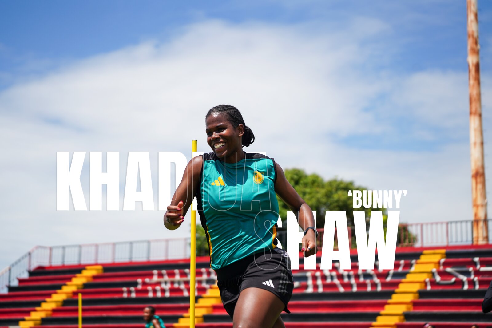 Khadija Bunny Shaw smiling in Reggae Girlz training kit with her name across the frame