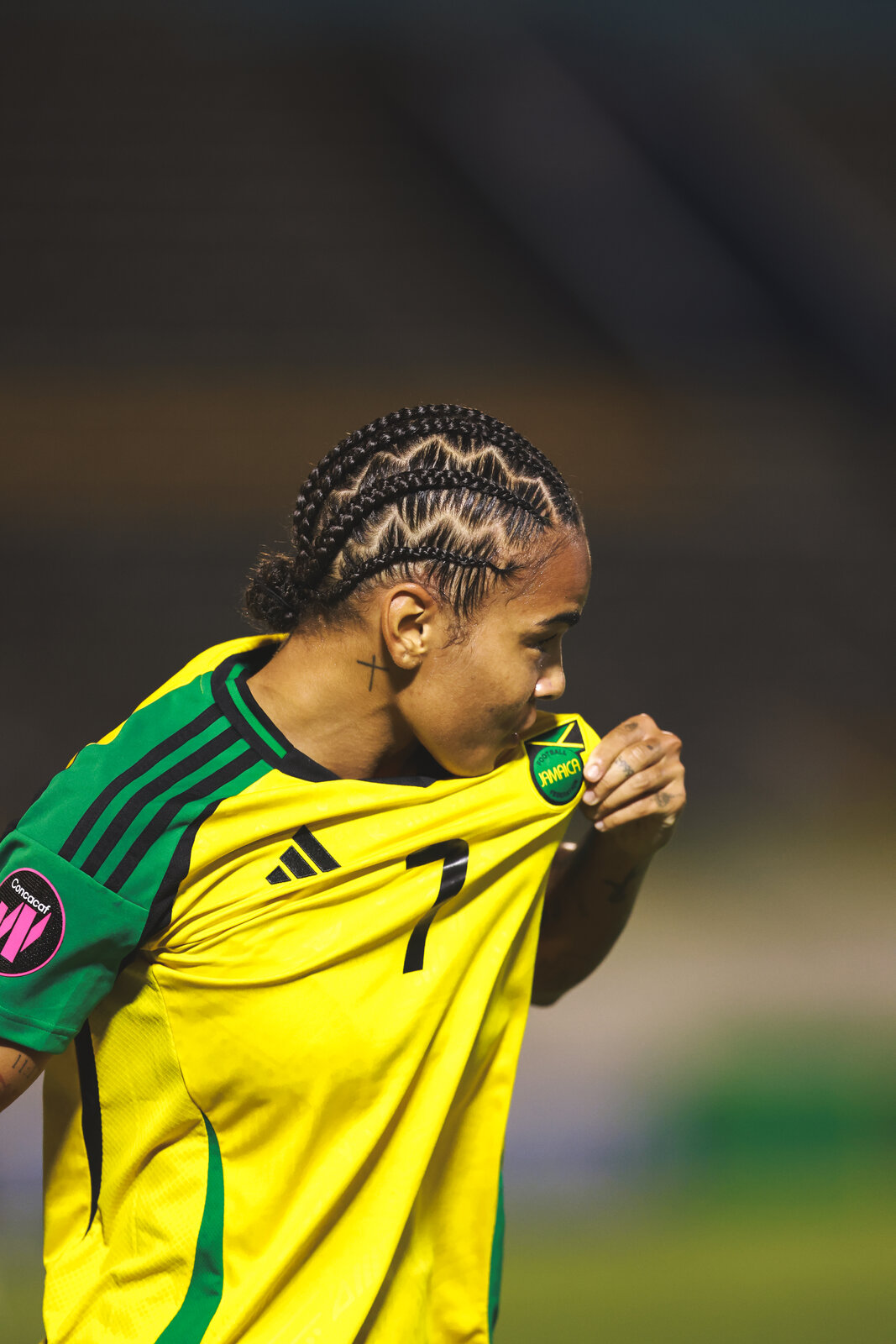 A Reggae Girlz player kisses the Jamaica badge on the number seven shirt