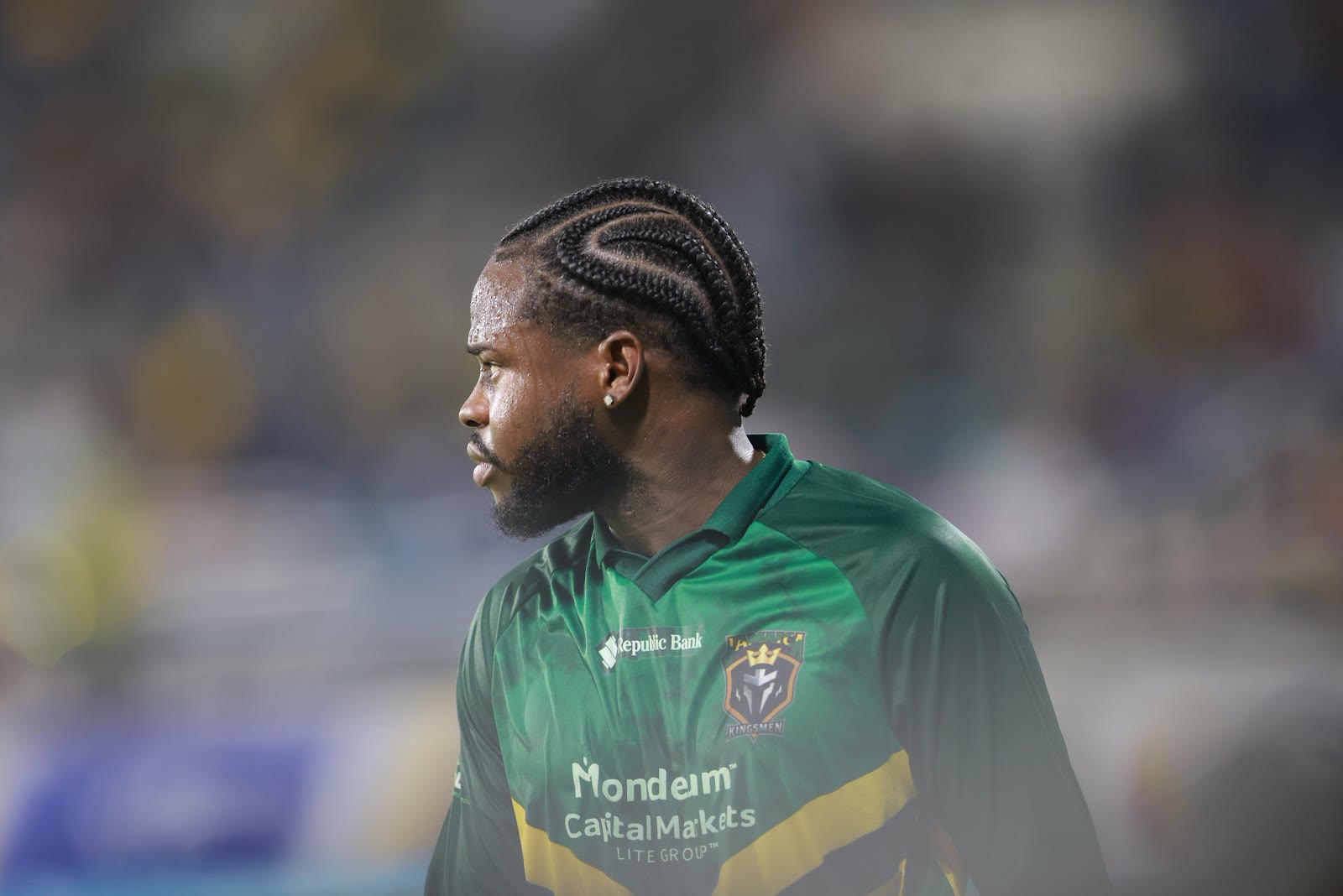 A Kingsmen player in the team kit looks out across the ground