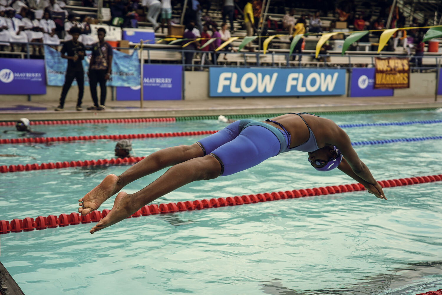 A swimmer streamlines into a dive at the pool
