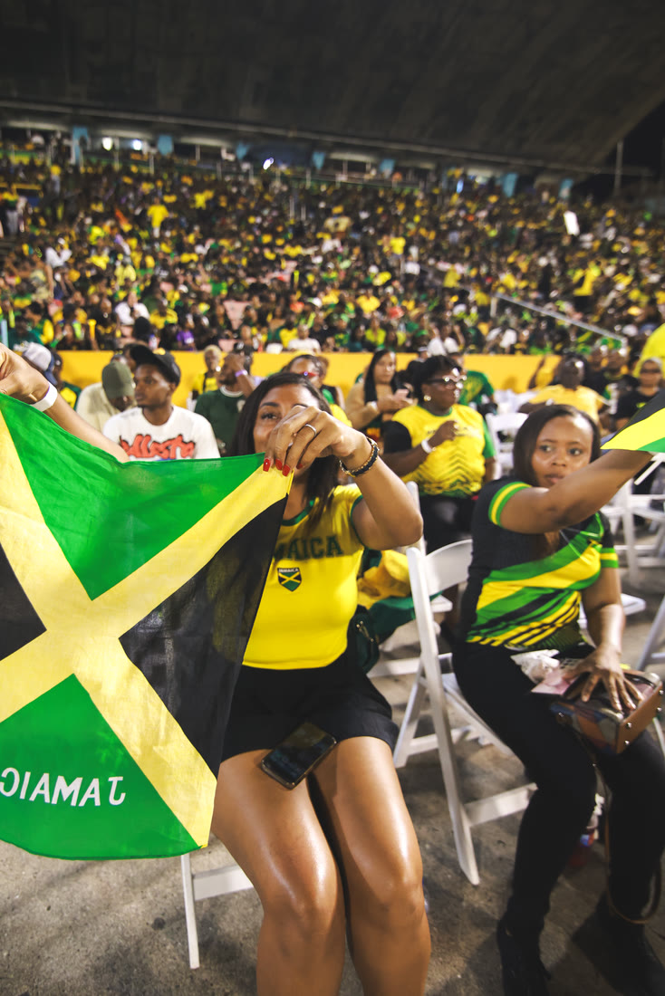 Supporters wave the Jamaican flag in the stands