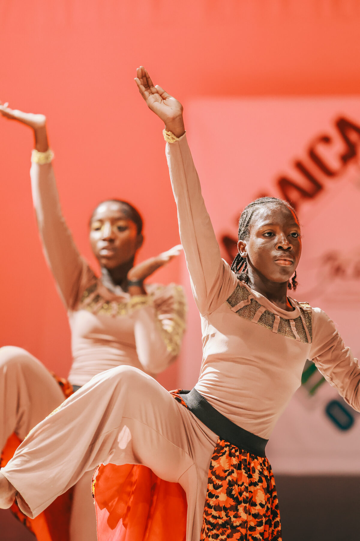 Dancers in elegant costume reach skyward mid-performance