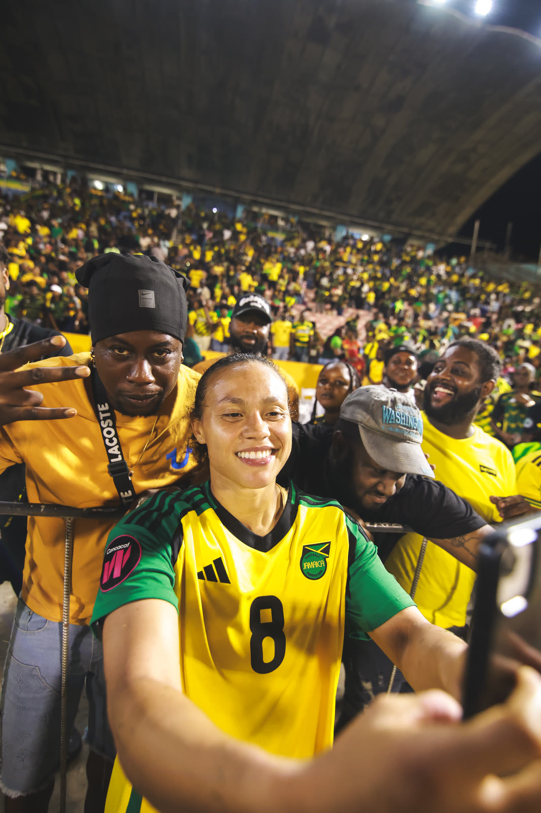 Number eight takes a selfie with fans in the stands after the win over Guyana
