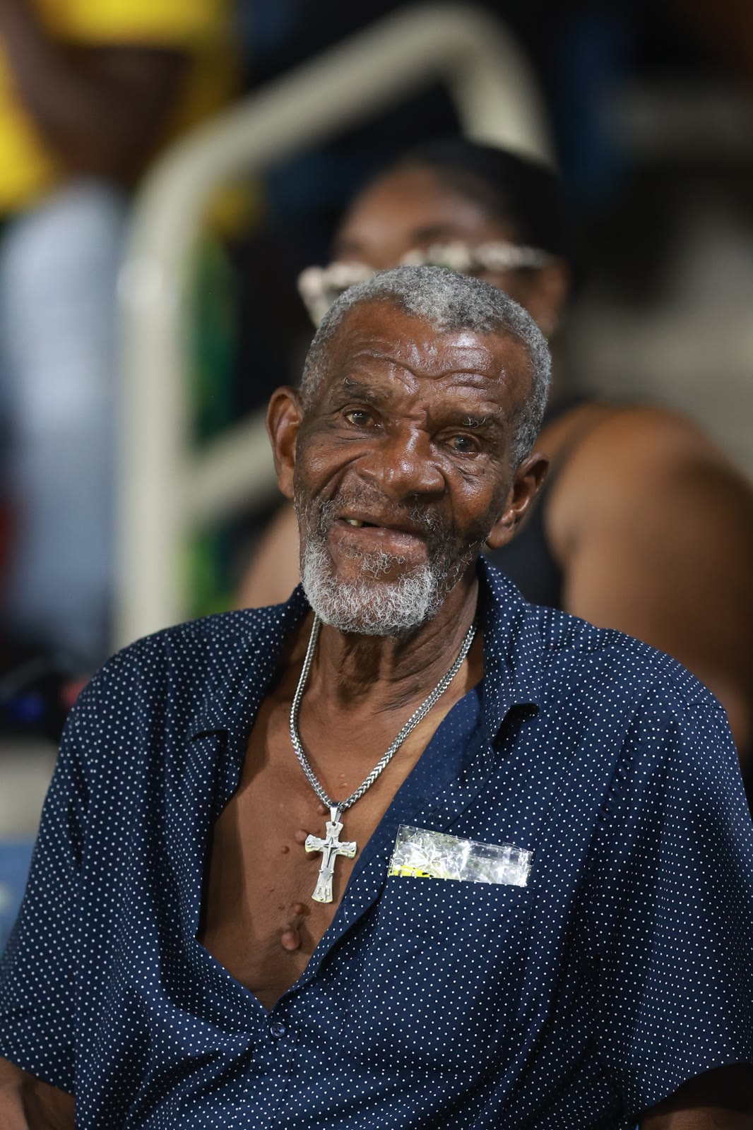 An elderly supporter smiles in the Sabina Park stands