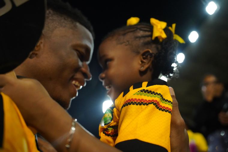 A player shares a smile with a young supporter after the match