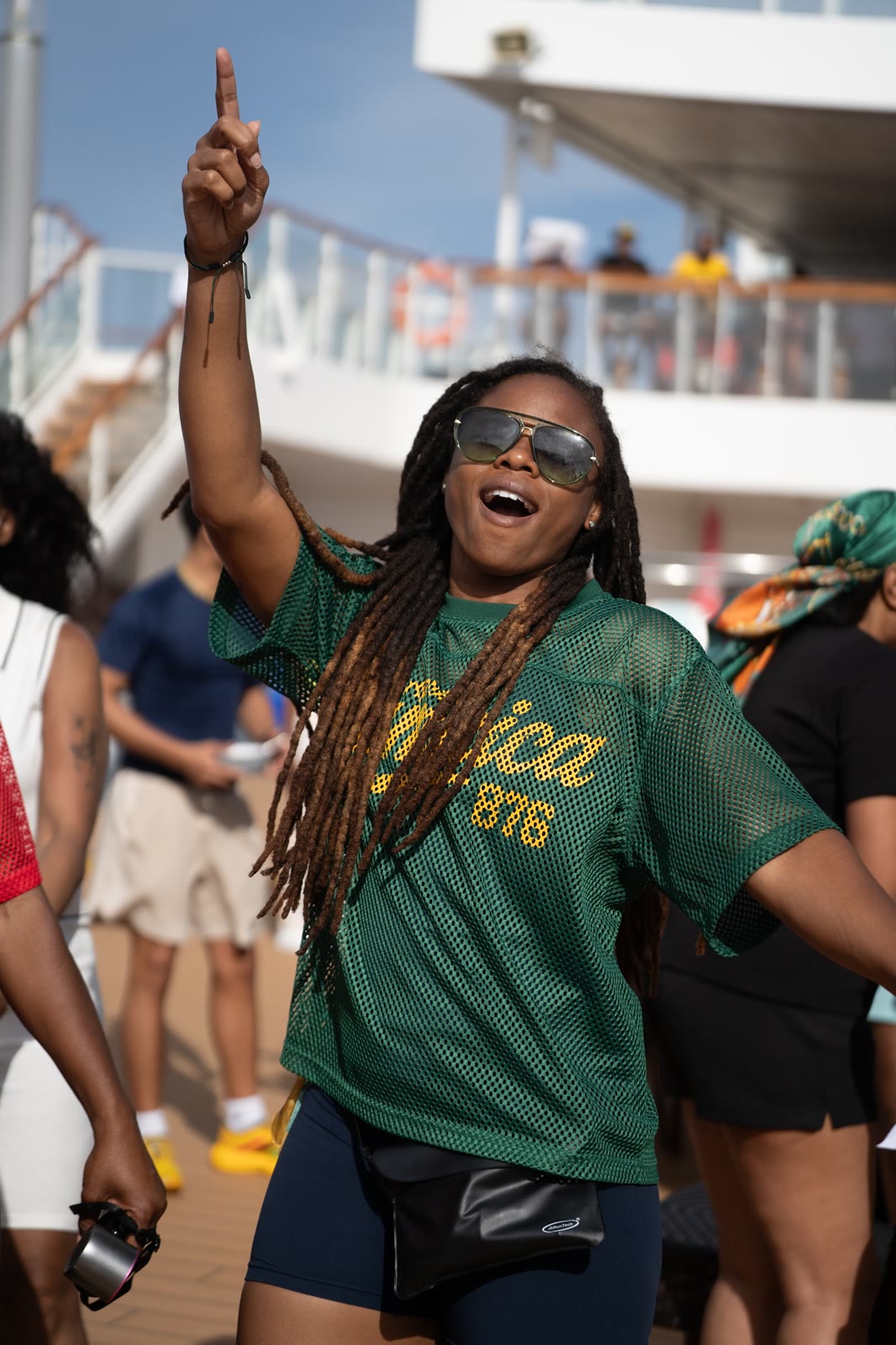 A guest in a Jamaica jersey celebrates at a deck party