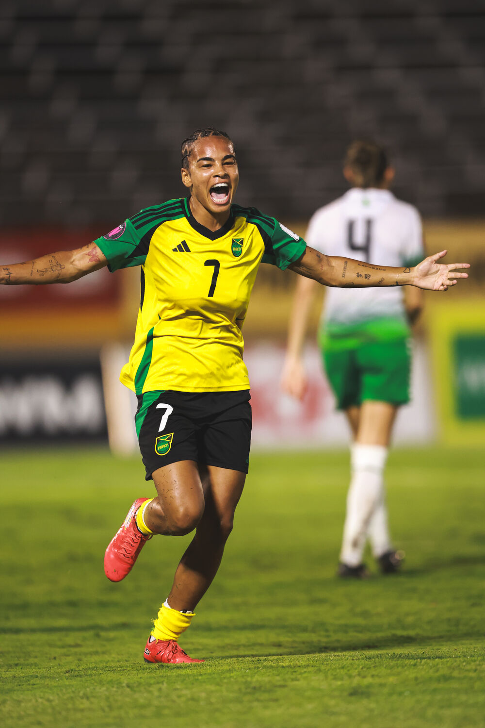 A player sprints away in celebration in green and gold