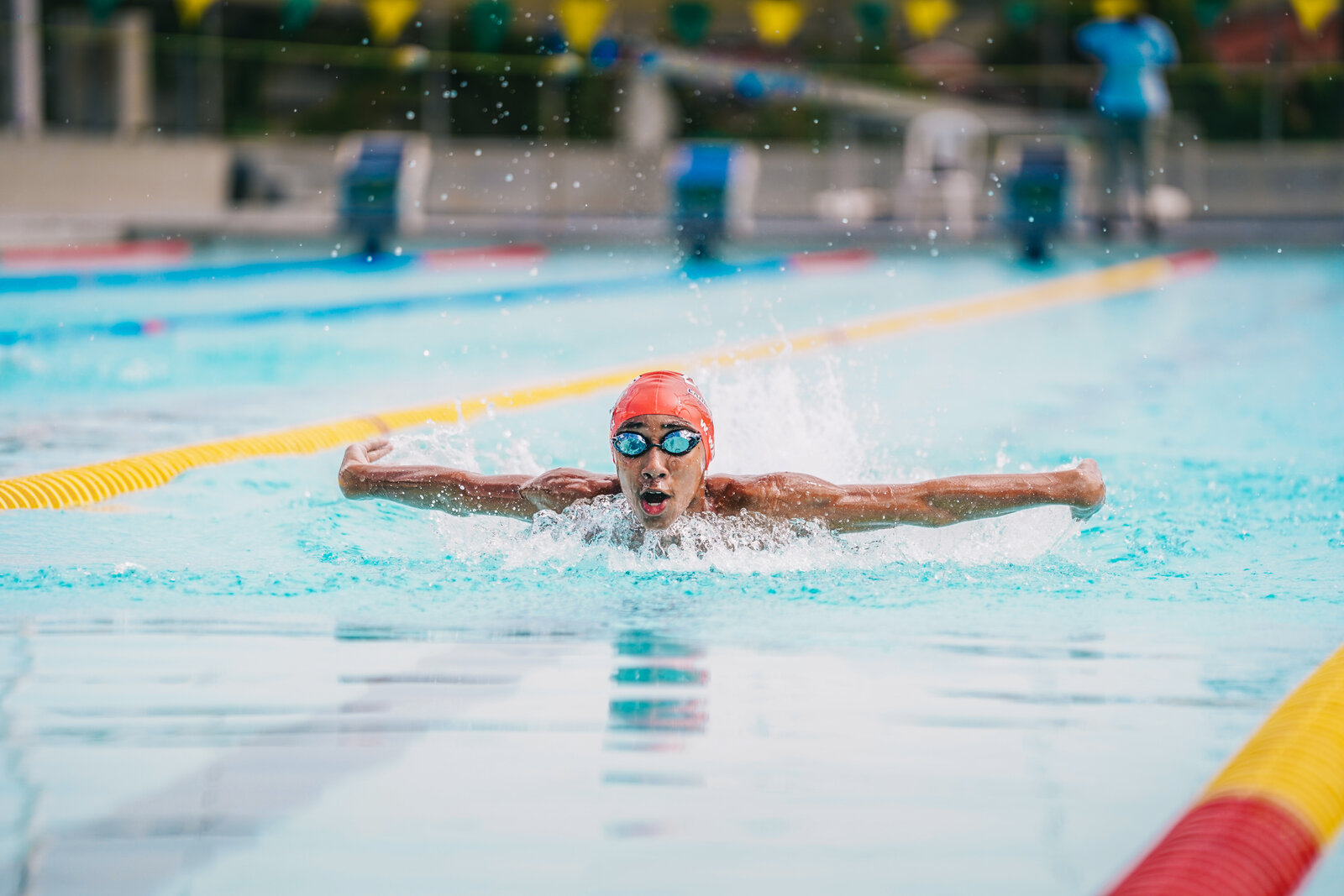 A swimmer mid-stroke down the competition lane