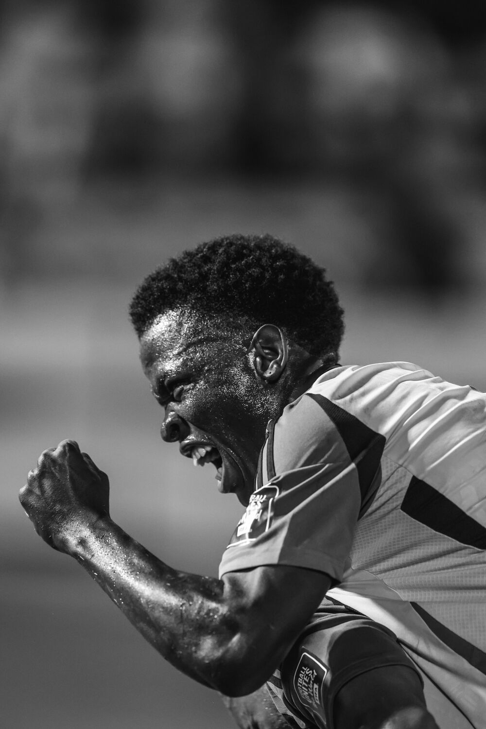 A sprinter at full effort, in black and white
