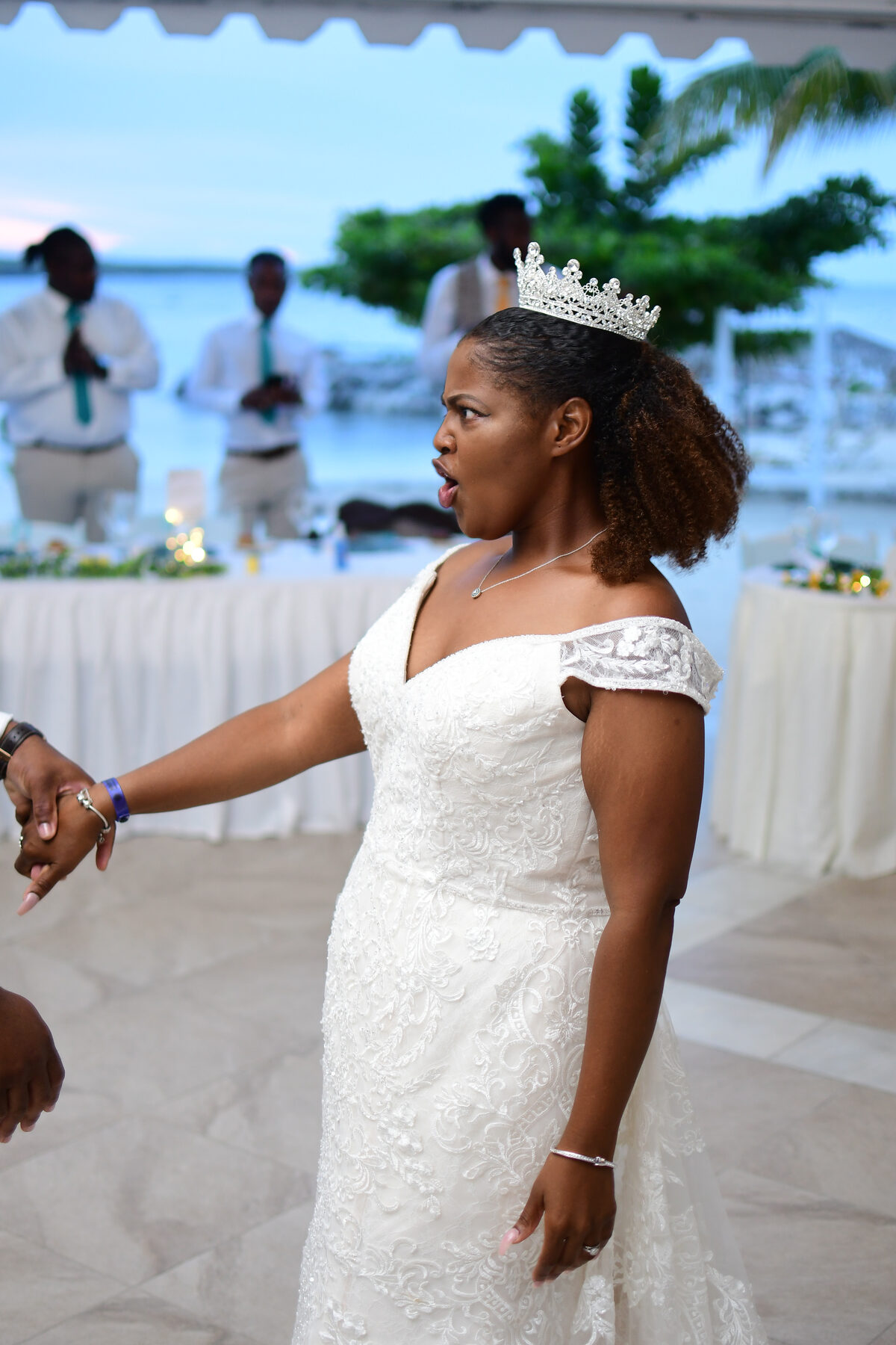 A bride in a white gown by the seaside