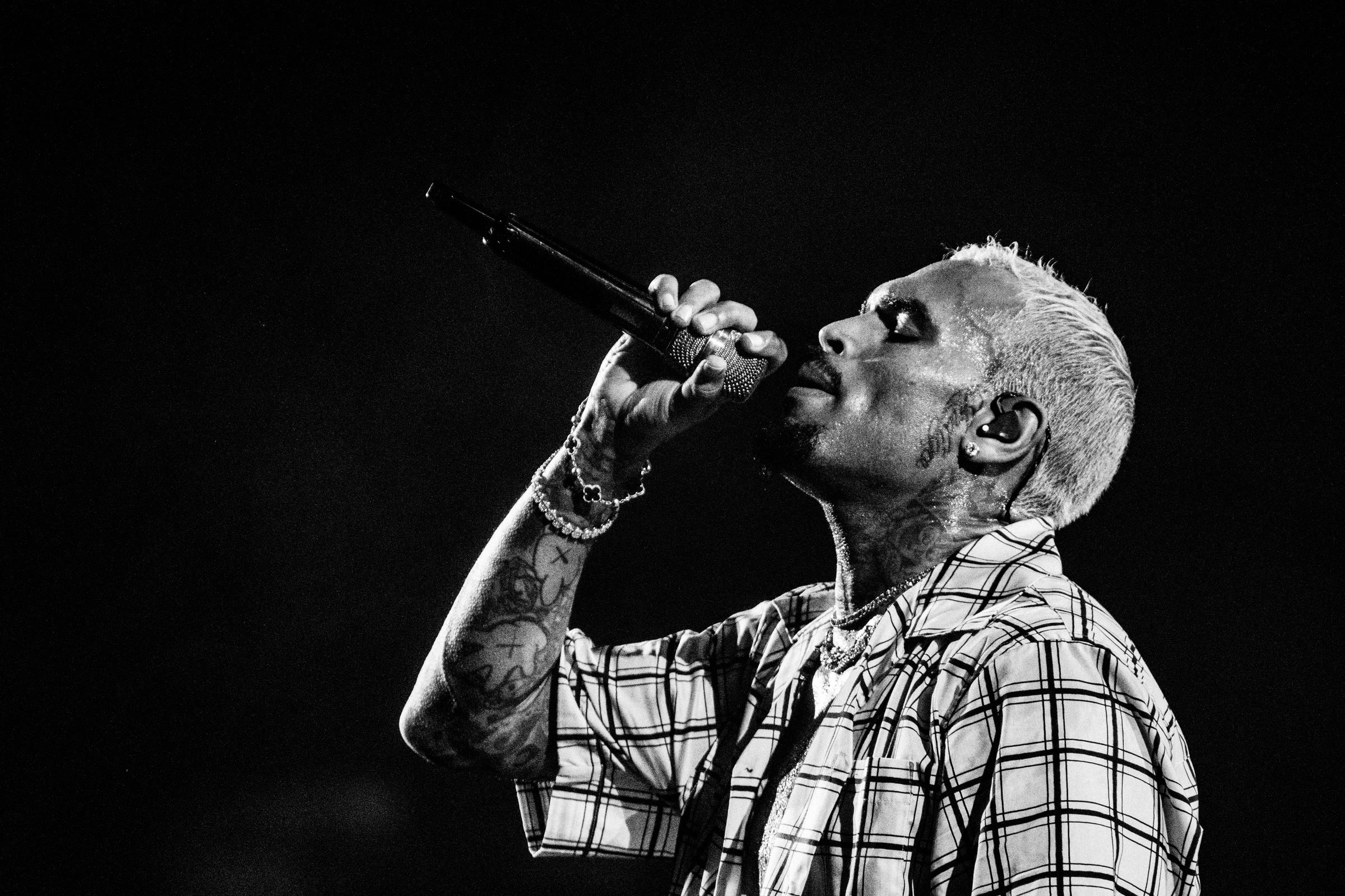 A black-and-white frame of Breezy singing