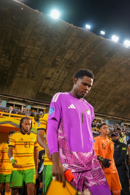 The goalkeeper leads the team through the tunnel