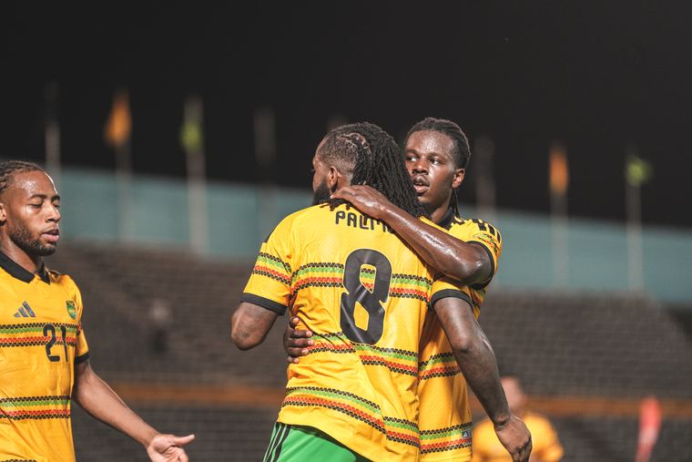 Reggae Boyz players embrace after the equaliser