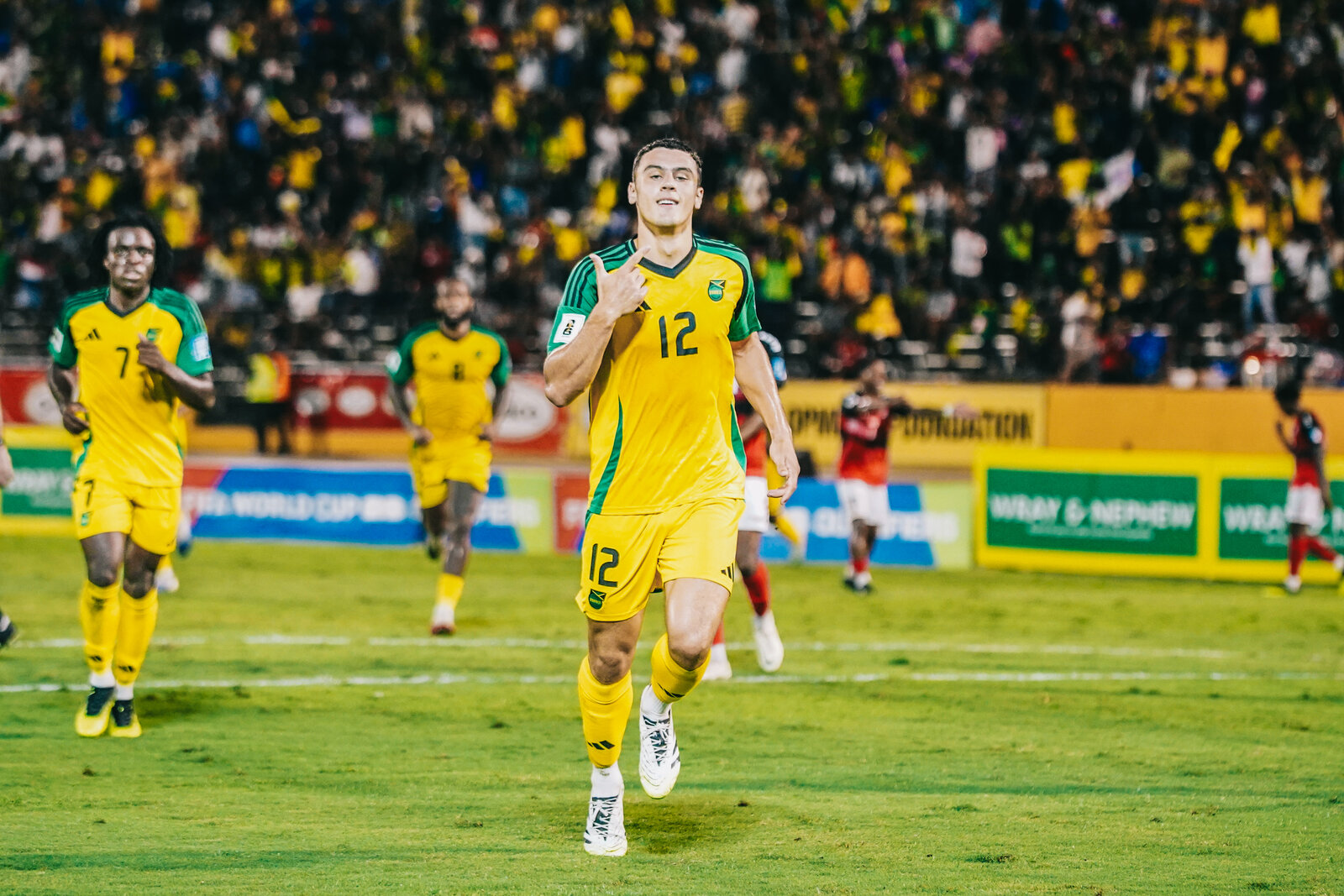 The Reggae Boyz squad walks out in front of the crowd