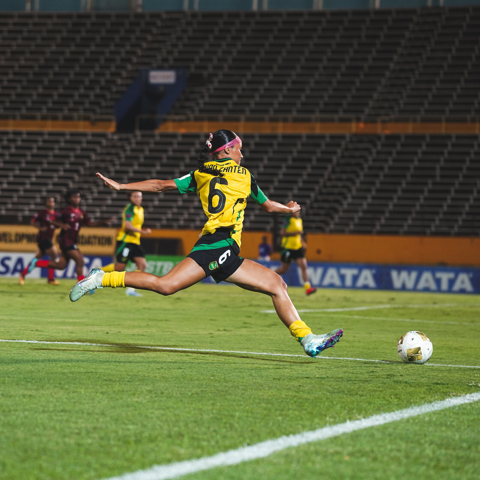 A Reggae Girlz player strikes the ball at goal