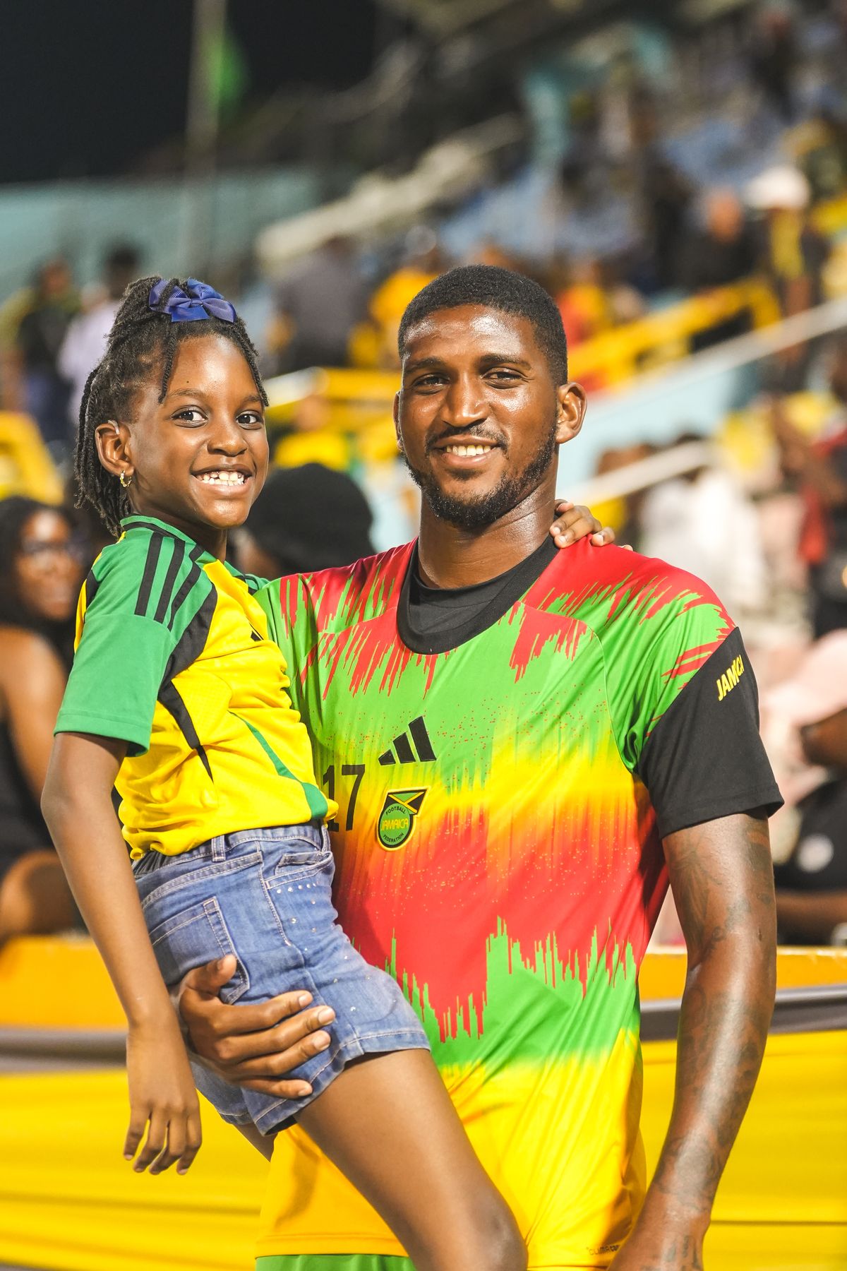 A young supporter in a Jamaica jersey held up at the National Stadium