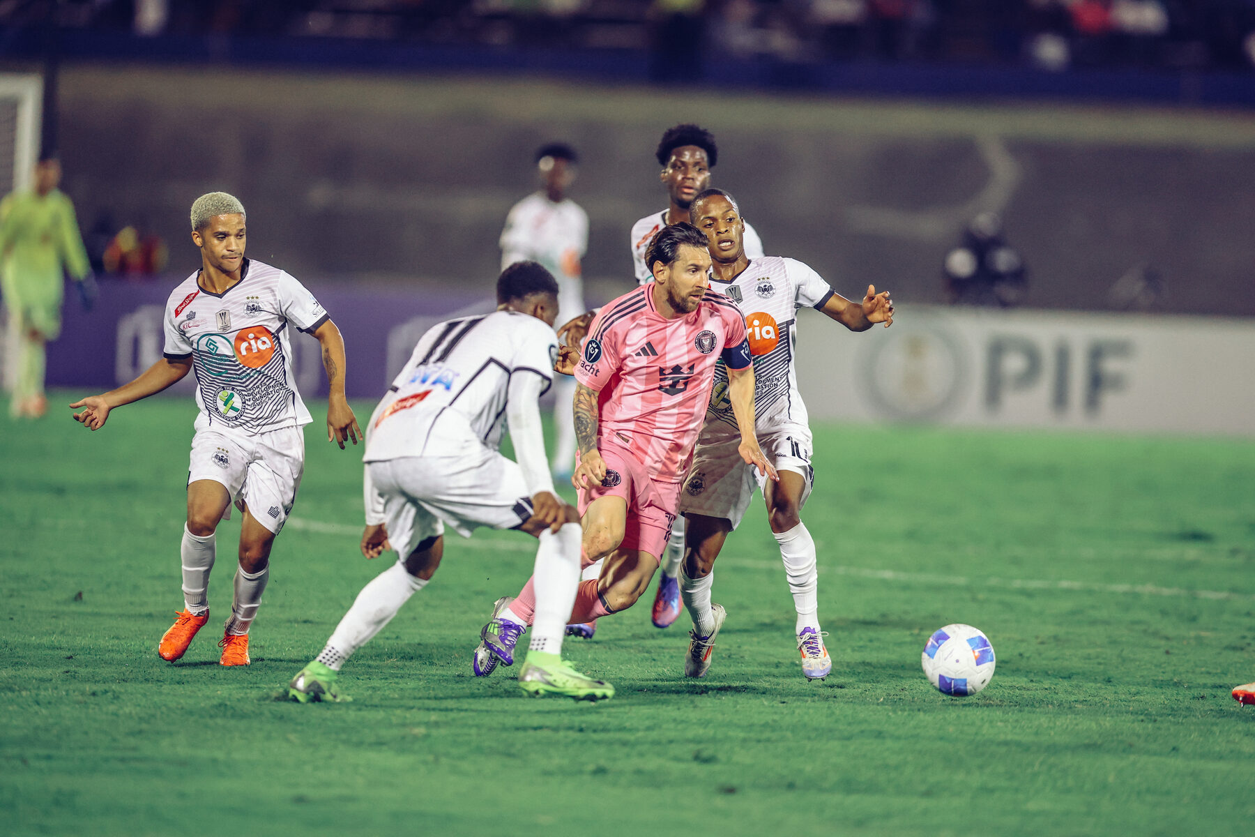 Lionel Messi driving through a crowd of defenders