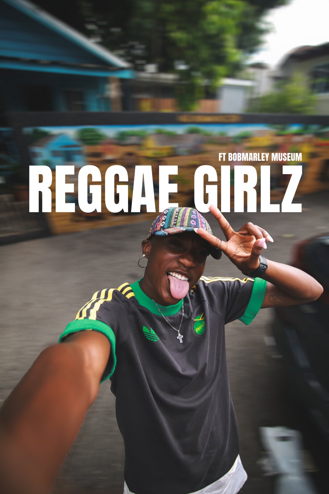 A Reggae Girl throws a peace sign in a selfie frame titled Reggae Girlz ft Bob Marley Museum