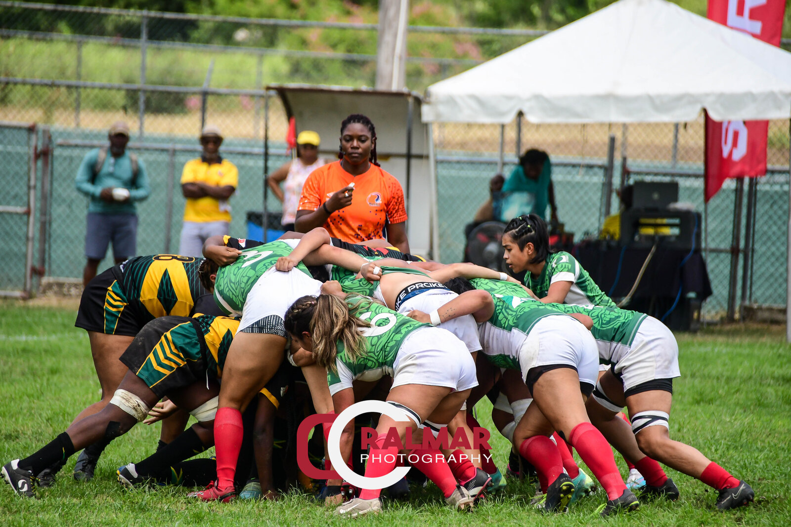 Two rugby packs lock into a scrum