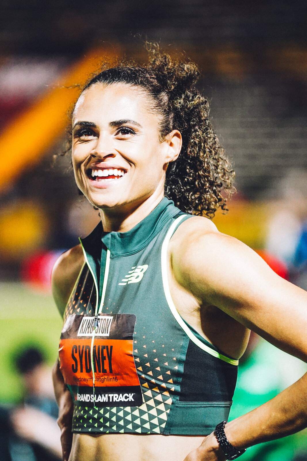 Sydney McLaughlin-Levrone smiling trackside at Grand Slam Track