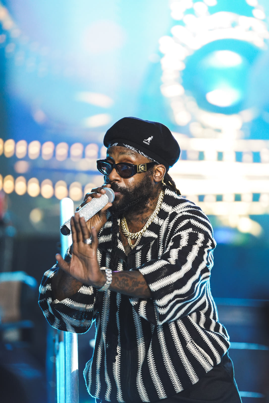 Tarrus Riley sings under blue stage light