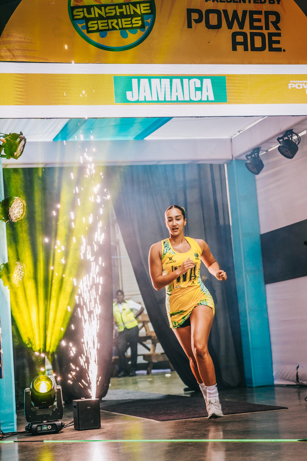 A Jamaica netballer walks out through pyro at player introductions
