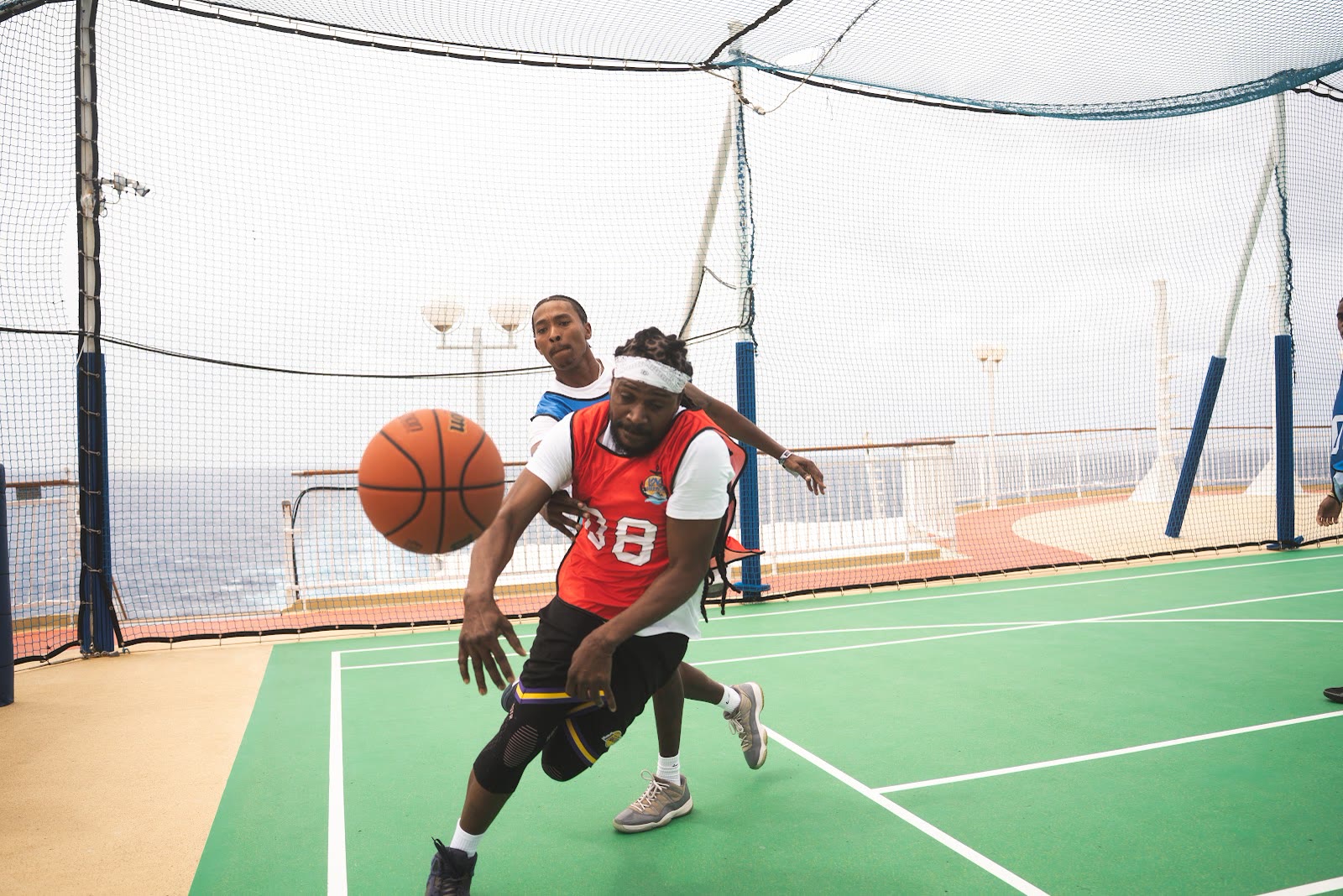 Guests play basketball on the top-deck court