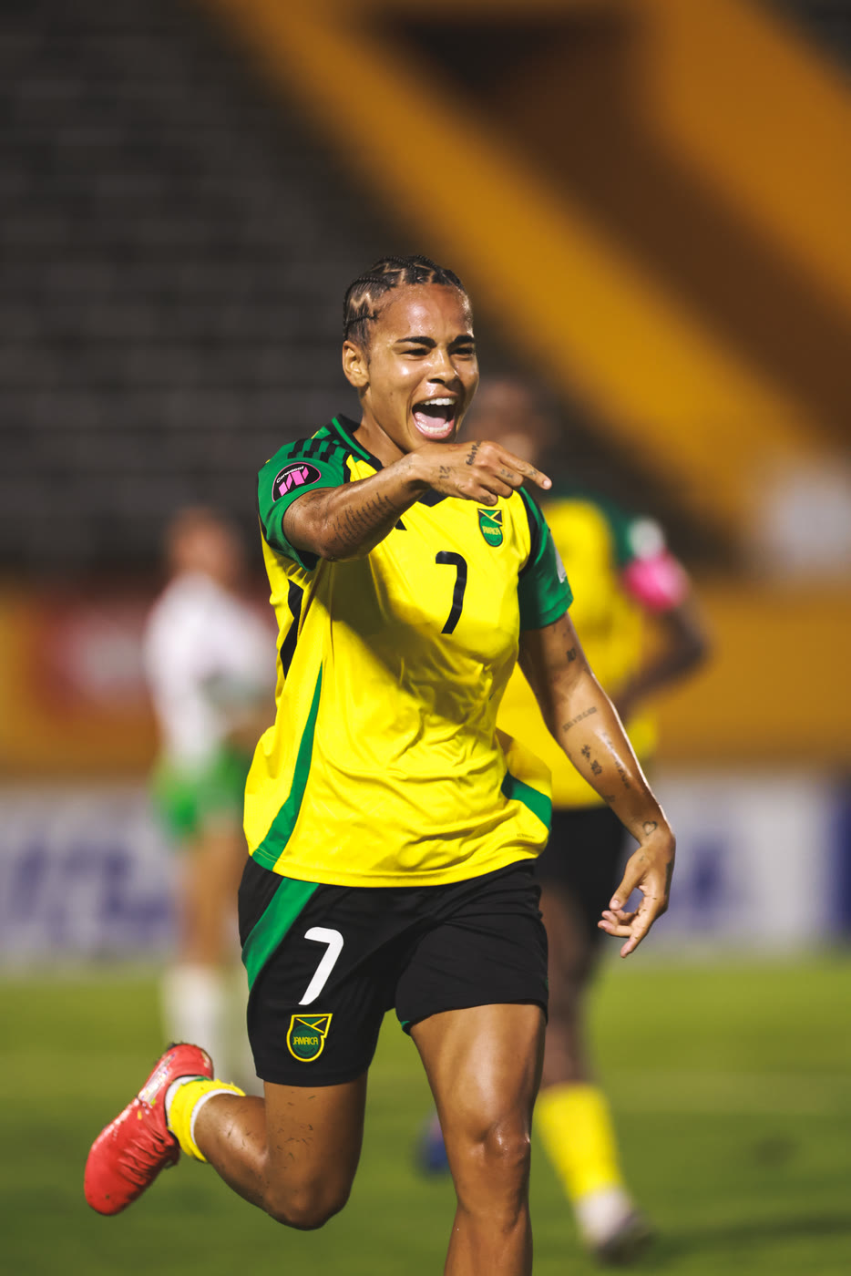 Frame 2 of three: number 7 points as she celebrates