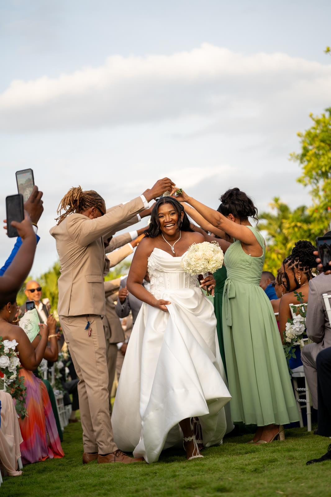The bride runs through an arch of raised hands