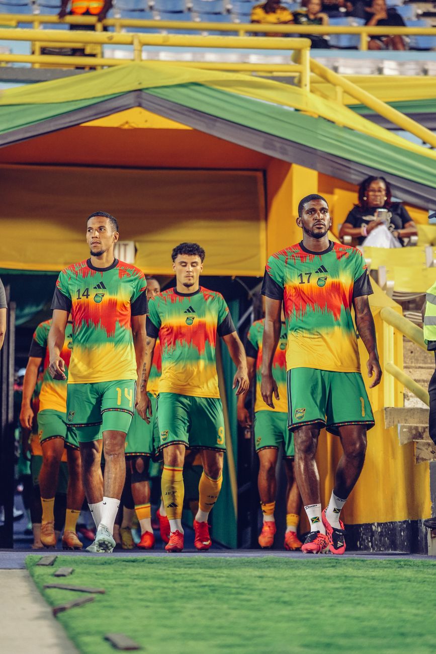 Players walk out of the tunnel in their warm-up tops