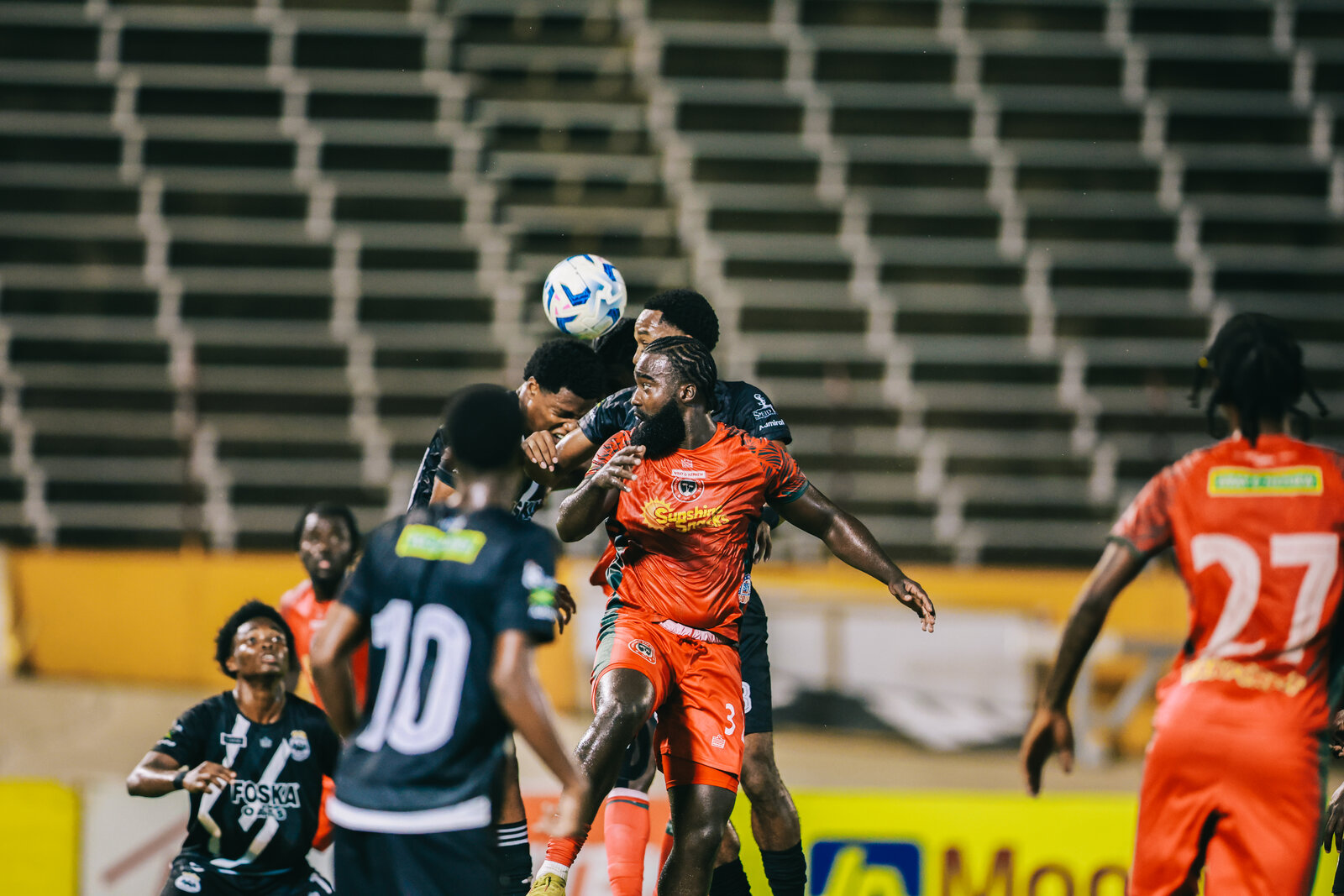 A crowded goalmouth header battle in a league match