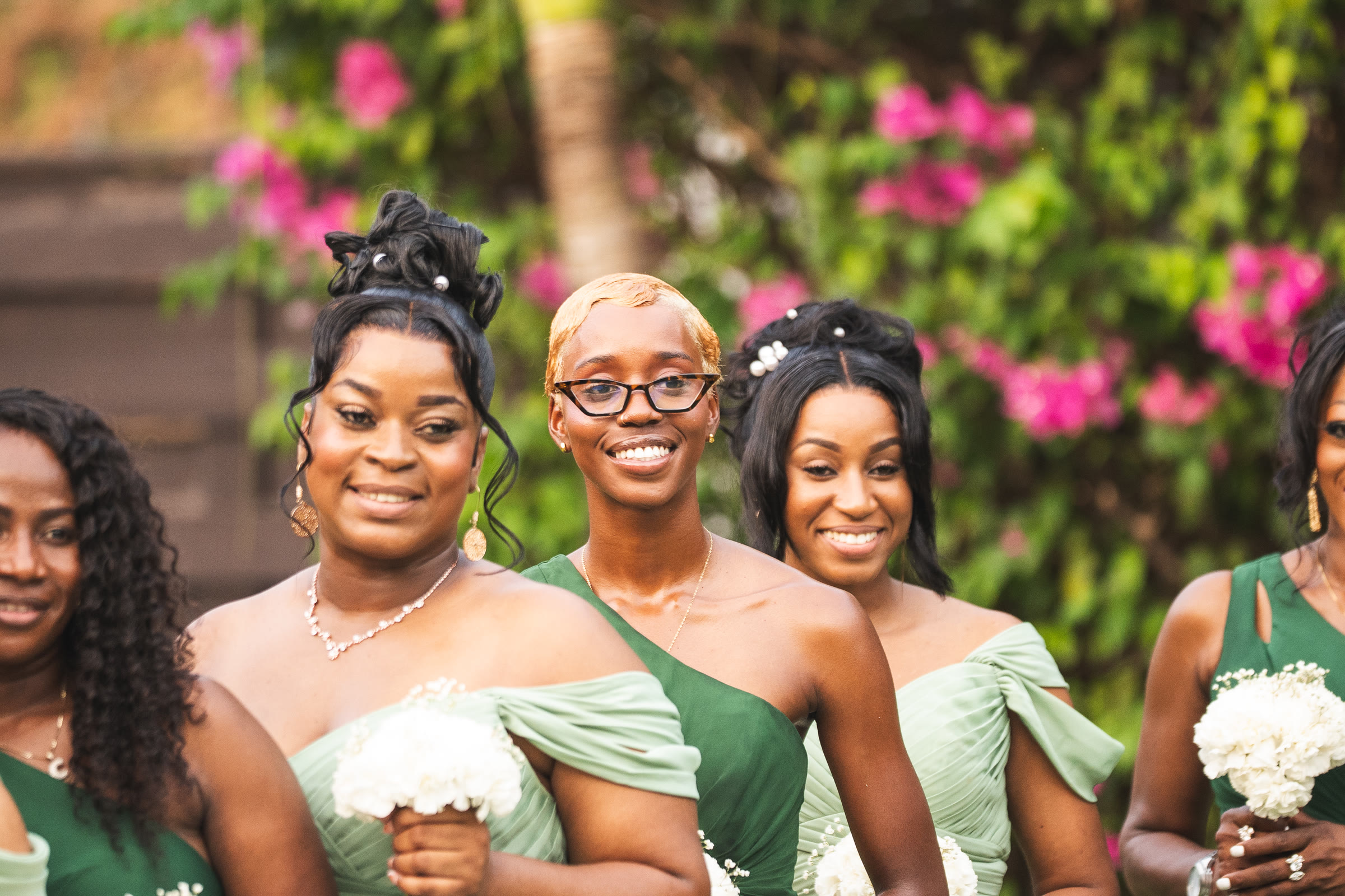 Bridesmaids in green smile together